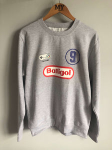 Sweatshirt displayed with Super Nintendo controller and Fiorentina memorabilia for 90s nostalgia.