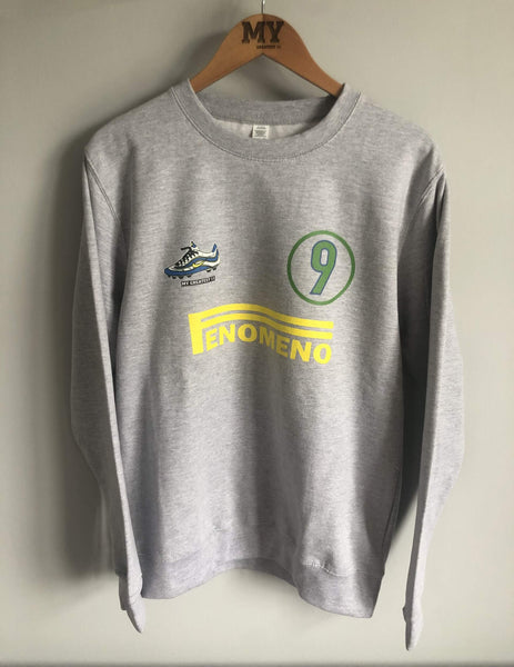 Full front view of the Ronaldo “OFenómeno” sweatshirt in heather grey hanging on a wooden hanger, featuring a bold graphic of Ronaldo and the Nike Mercurial R9 boot.
