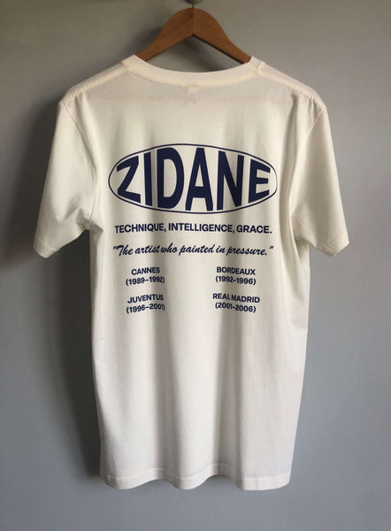 Back view of the Zidane Essentials Tee showcasing a printed timeline and the quote: “The artist who painted in pressure.”