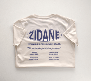Back view of the Zidane Essentials Tee showcasing a printed timeline and the quote: “The artist who painted in pressure.”