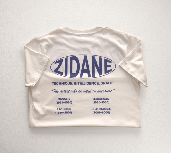 Back view of the Zidane Essentials Tee showcasing a printed timeline and the quote: “The artist who painted in pressure.”