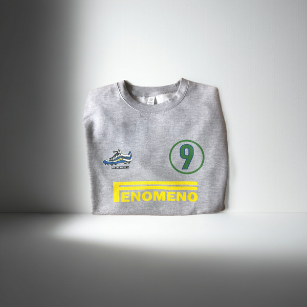 Front view of the Ronaldo “OFenómeno” sweatshirt in heather grey, featuring a bold graphic of Ronaldo and the iconic Nike Mercurial R9 boot.