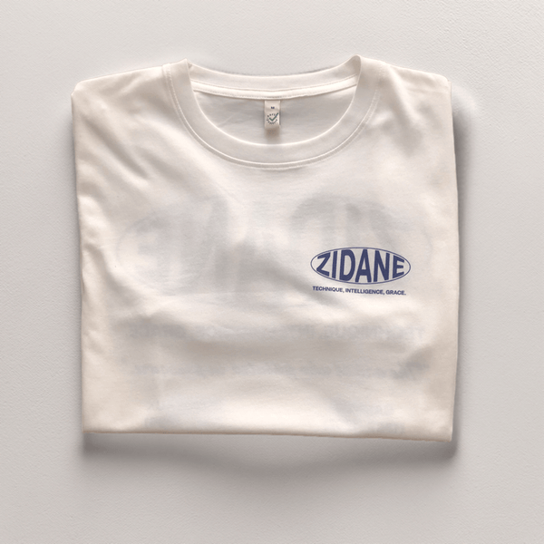 Front view of the off-white Zidane Essentials Tee featuring bold navy typography.